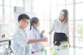 Student doing experiment with their teacher in chemistry classroom