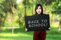 Young asian student girl holding board with back to school Royalty Free Stock Photo