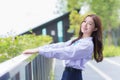 Young Asian student girl in school uniform is smiling with braces on teeth in a park in the middle of the city Royalty Free Stock Photo