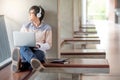 Young Asian student man using laptop in college Royalty Free Stock Photo