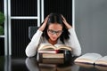 Young asian student reading a book under mental pressure