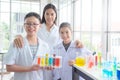 Student smiling with their teacher in chemistry classroom