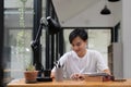 Young asian student using digital tablet remote studying, watching online webinar, zoom virtual training on video call Royalty Free Stock Photo
