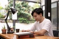 Young asian student using digital tablet remote studying, watching online webinar, zoom virtual training on video call Royalty Free Stock Photo