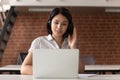 Young asian support service female worker in earphones consulting client.