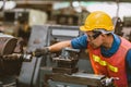 Young Asian Technician Engineer Staff Worker using Lathe CNC Milling Machine work in Heavy Metal Factory. Royalty Free Stock Photo