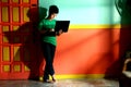 Young asian teen with a laptop computer in a living room Royalty Free Stock Photo