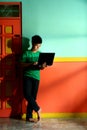 Young asian teen with a laptop computer in a living room Royalty Free Stock Photo