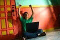 Young asian teen with a laptop computer in a living room Royalty Free Stock Photo