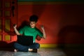 Young asian teen with a laptop computer in a living room Royalty Free Stock Photo