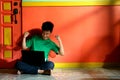 Young asian teen with a laptop computer in a living room