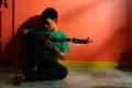 Young asian teen playing the guitar in a living room Royalty Free Stock Photo