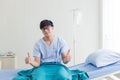 Young Asian teenage patient man showing thumbs up with happy smiley face in the hospital Royalty Free Stock Photo