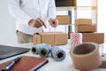 Young asian teenage product owners are packing small business packaging products in boxes prepared for shipping Royalty Free Stock Photo