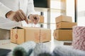 Young asian teenage product owners are packing small business packaging products in boxes prepared for shipping Royalty Free Stock Photo