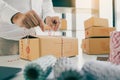 Young asian teenage product owners are packing small business packaging products in boxes prepared for shipping Royalty Free Stock Photo