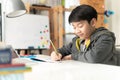 Young asian teenage student doing homework . Royalty Free Stock Photo