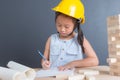 Young asian Thai girl kid in yellow safety helmet Royalty Free Stock Photo