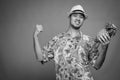 Young Asian tourist man ready for vacation against gray background Royalty Free Stock Photo