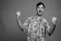 Young Asian tourist man ready for vacation against gray background Royalty Free Stock Photo