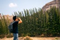 Young Asian tourist trekking with backpack holding binoculars