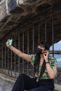 Young Asian tourist woman taking a selfie with her smartphone. Royalty Free Stock Photo