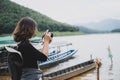 Young Asian tourists spend their free time touring natural lakes. Likes to take pictures as a hobby