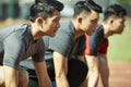 Young asian sprinters on starting line