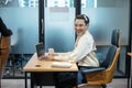 Young asian transvestite office worker working with laptop and document at desk in the office