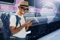 Young asian traveler with backpack in the railway, Backpack and hat at the train station with a traveler, Travel concept, Young tr