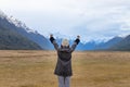 Young Asian traveler celebrating success at Eglinton Valley, Te anua, South Island, New Zealand