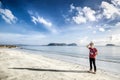 Young traveler poses in a beautiful day at the beach