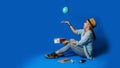 Young asian traveler happy in blue shirt holding passport with holding ball world in the hand. concept travel with equipment for