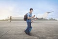 Young asian traveler walking with bags and cellphone Royalty Free Stock Photo