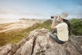 Young Asian traveler woman looking a binoculars. Royalty Free Stock Photo