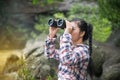 Young Asian traveler woman looking a binoculars. Royalty Free Stock Photo