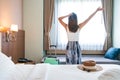 Young Asian traveler woman relaxing in hotel room after check-in. Travel and summer holiday concept Royalty Free Stock Photo