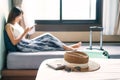 Young Asian traveler woman relaxing in hotel room after check-in. Travel and summer holiday concept