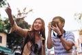 Young Asian travelers taking photo of city