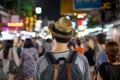 Young Asian traveling backpacker in Khaosan Road night market in evening in Bangkok, Thailand. Royalty Free Stock Photo