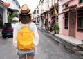 Young asian traveling backpacker in Khaosan Road outdoor market in Bangkok, Thailand Royalty Free Stock Photo