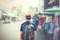 Young Asian traveling backpacker in Khaosan Road outdoor market