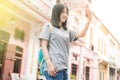 Young Asian traveling blogger or backpacker using route application on the mobile phone to find the needed address in a city. Royalty Free Stock Photo