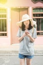 Young Asian traveling blogger or backpacker using route application on the mobile phone to find the needed address in a city Royalty Free Stock Photo