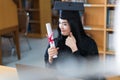 A young Asian university graduate woman in graduation gown expressing joy and excitement to celebrate her education achievement in Royalty Free Stock Photo