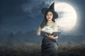 Young asian witch woman reading the spell books Royalty Free Stock Photo