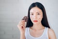 Young Asian Woman Acne Problem Face with Chocolate