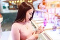 Young asian woman applying and choose to buy perfume in duty free store at international airport
