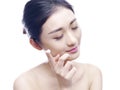 Young asian woman applying lotion to face Royalty Free Stock Photo