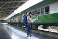 Young Asian woman backpacker is enjoy traveling by Train at Train station